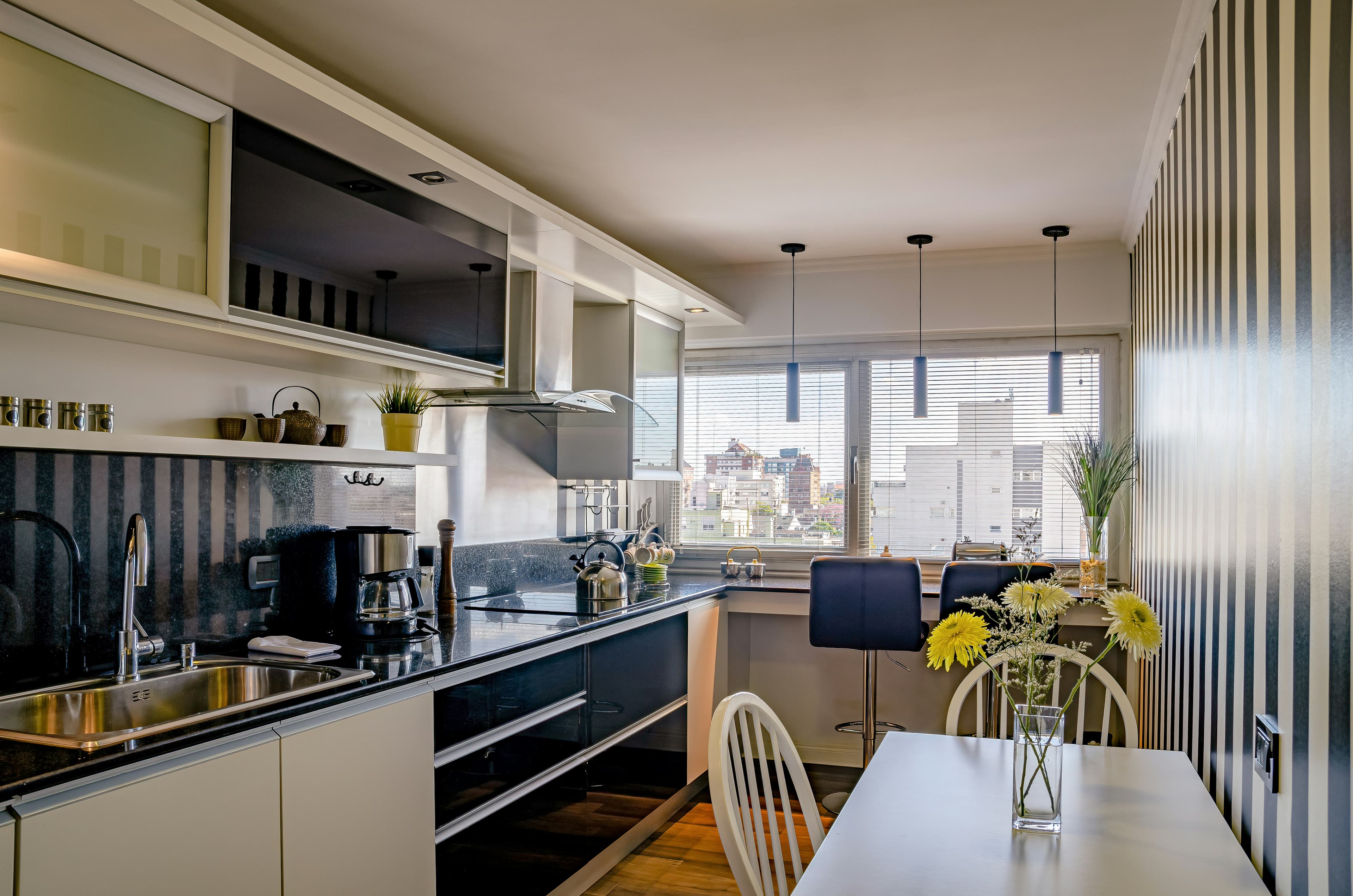 A bright, modern kitchen and dining space overlooking the city