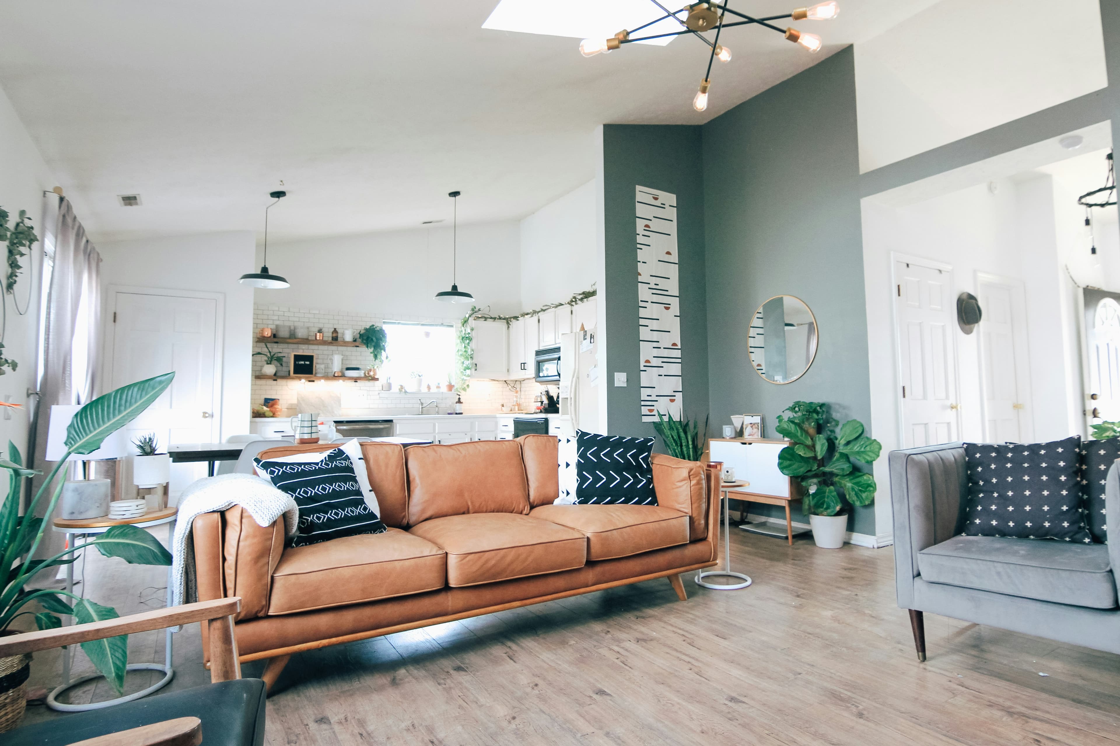 Cozy, plant-filled living room with a leather sofa